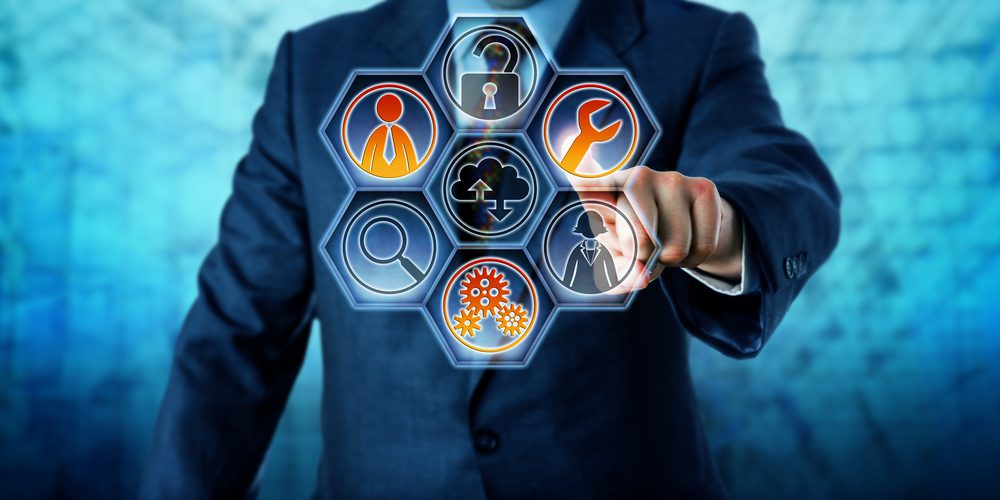A person in a suit touches a transparent touchscreen with hexagonal icons representing business concepts, including Threat Prevention, security, cloud computing, tools, gears, search, people, and Managed IT Services.